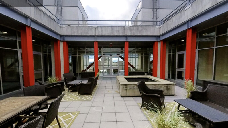 a courtyard with tables and chairs