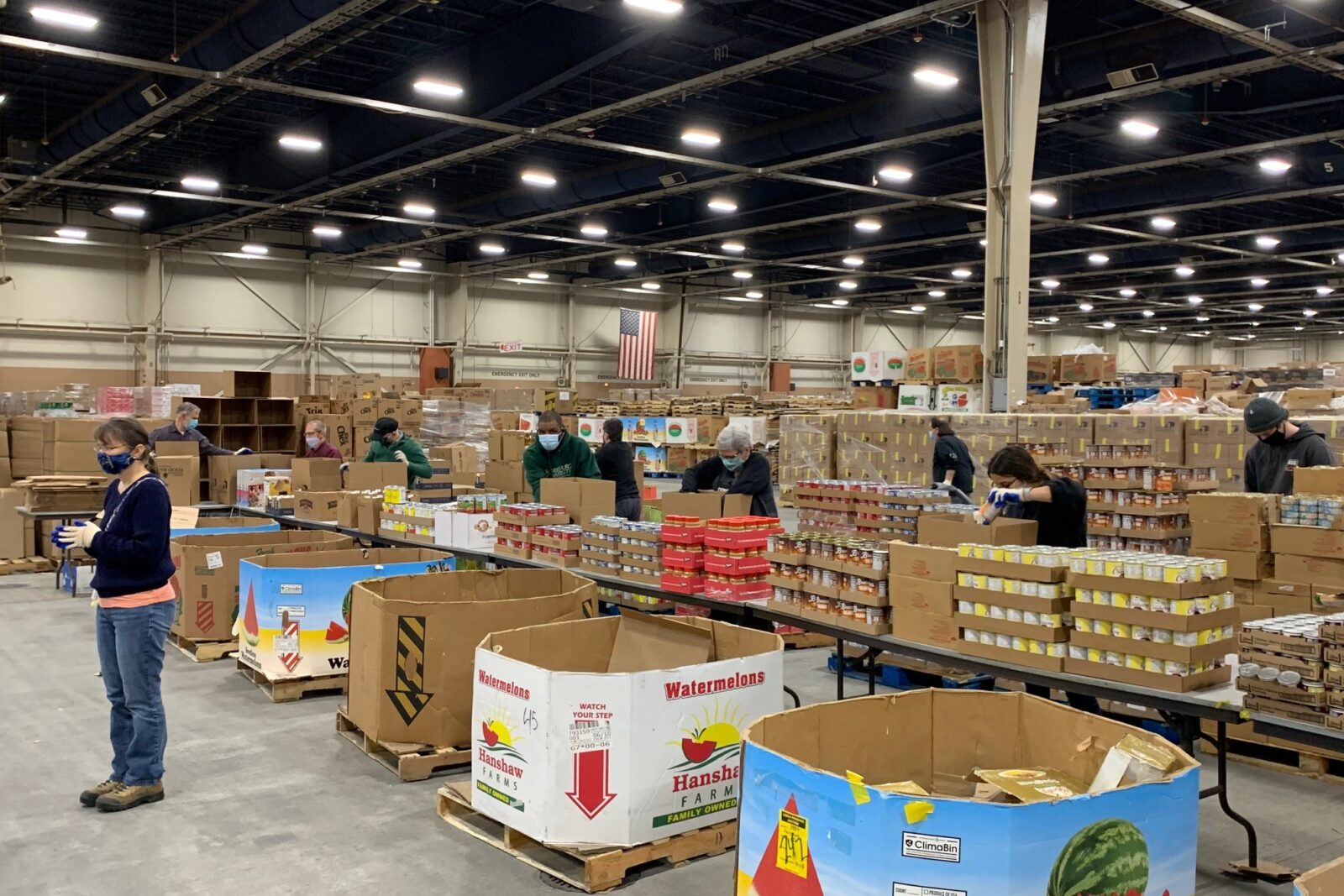 a large room with boxes and people in it