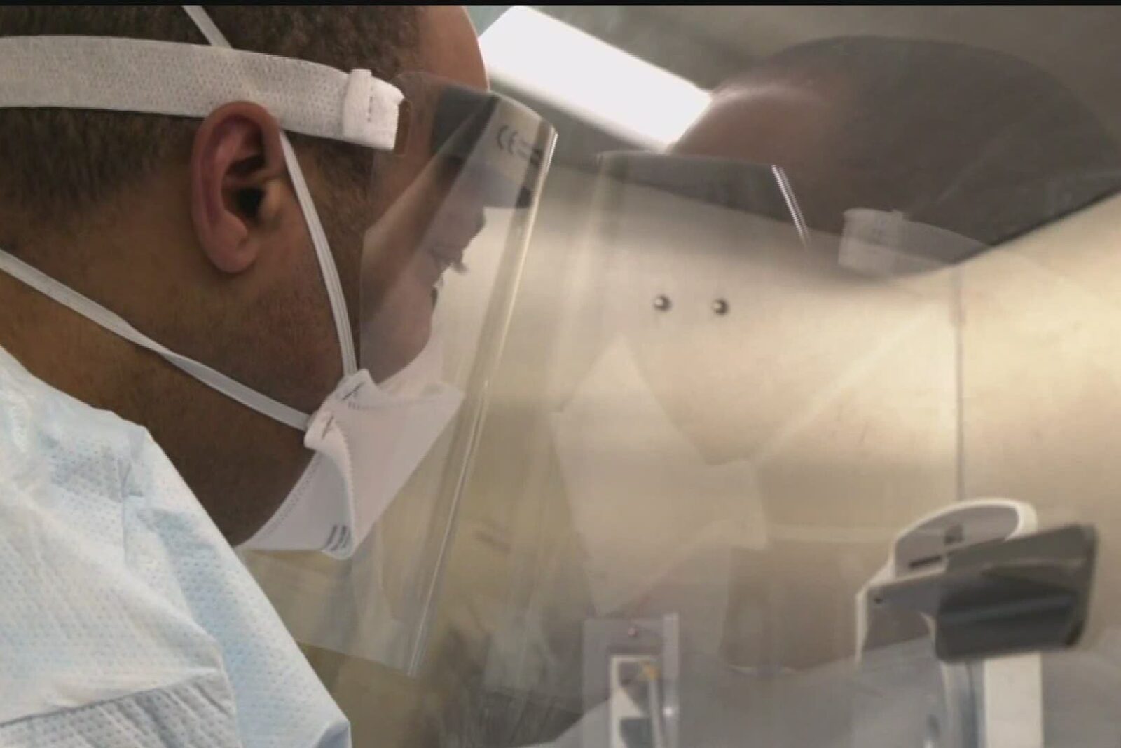 a person wearing a white lab coat and a white lab coat
