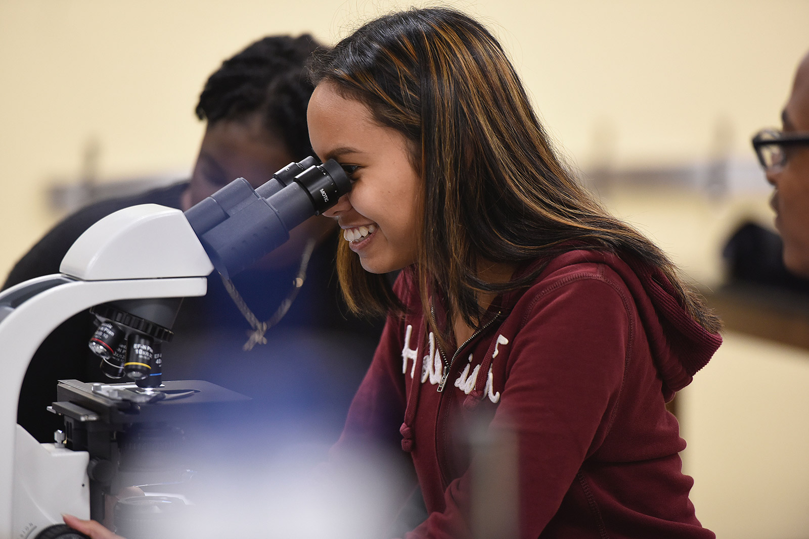 a person looking through a microscope