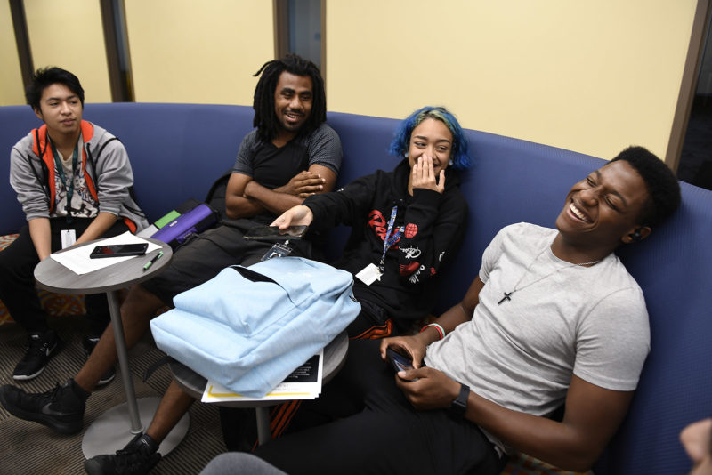 Four students on a blue couch