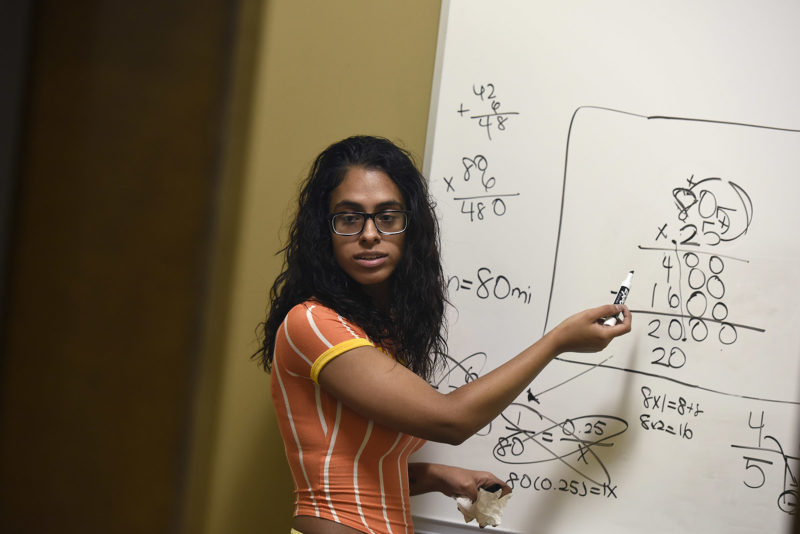 Student doing math on a whiteboard
