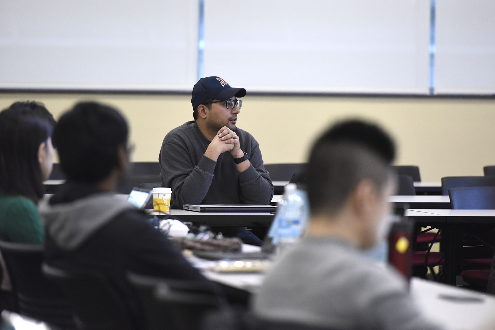a person speaking to a group of people in a classroom