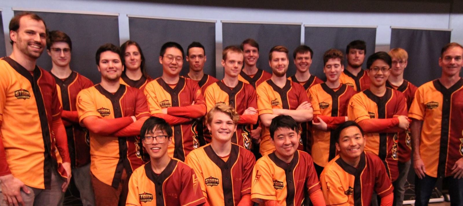 a group of people wearing orange shirts