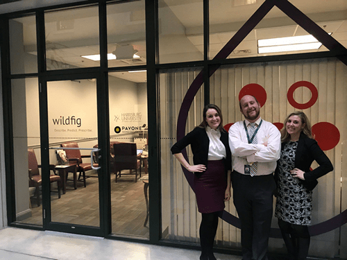 Three people standing in front of alumni career services office
