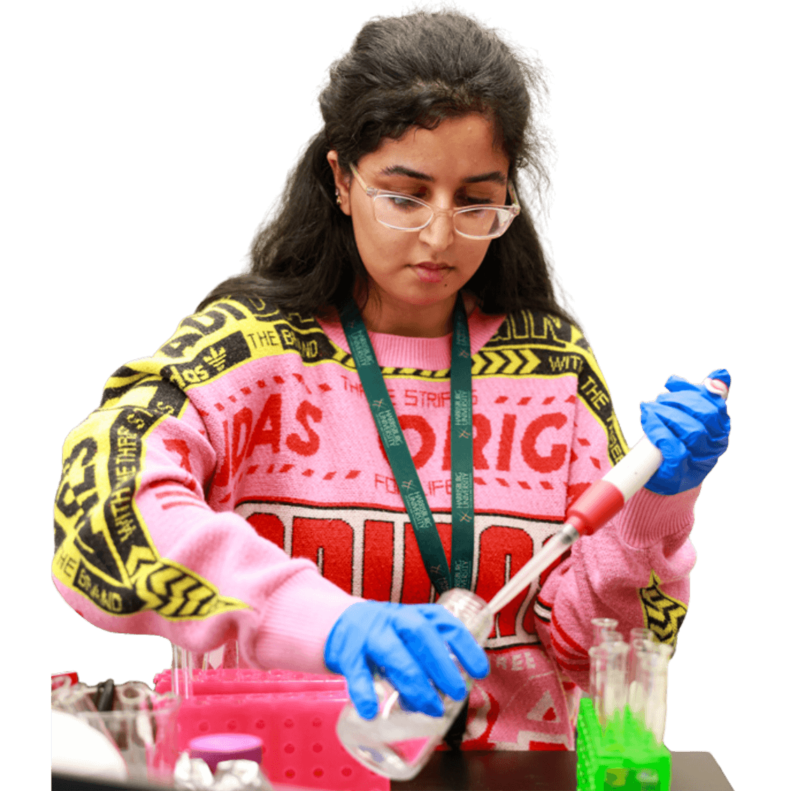 a college student wearing safety goggles and gloves doing science experiment