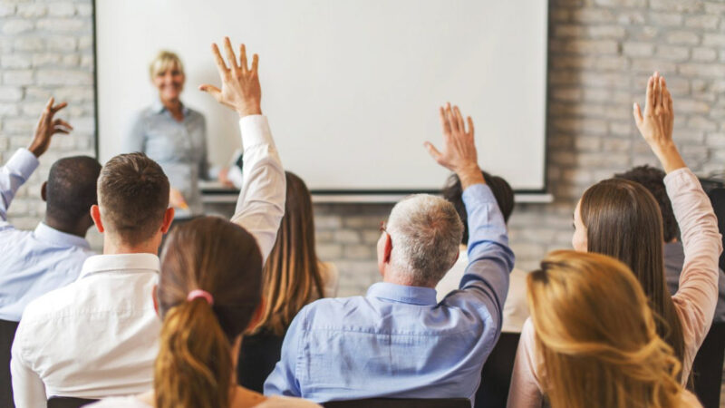 a group of people raising their hands