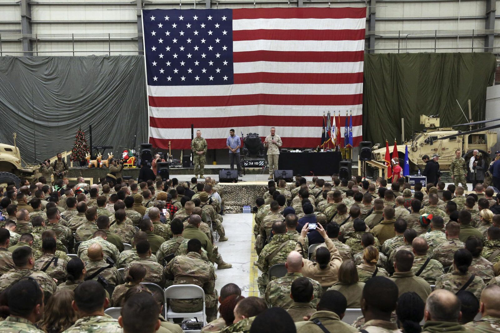 a group of people in a room with a flag
