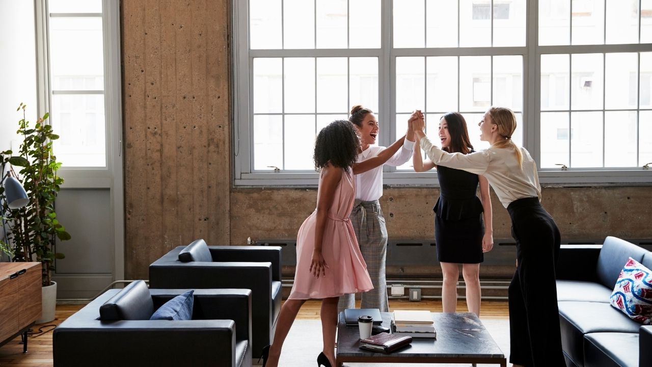 women high fiving
